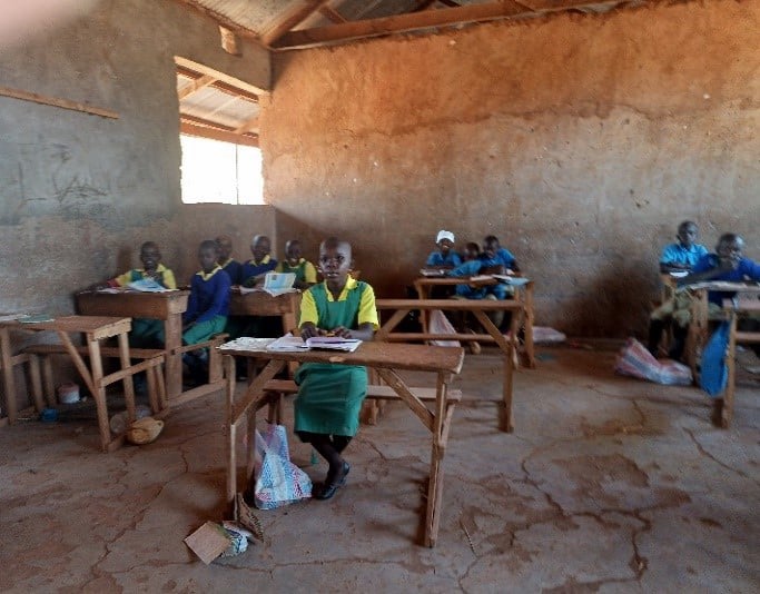 Pupils inside the old classrooms at Kajiampau